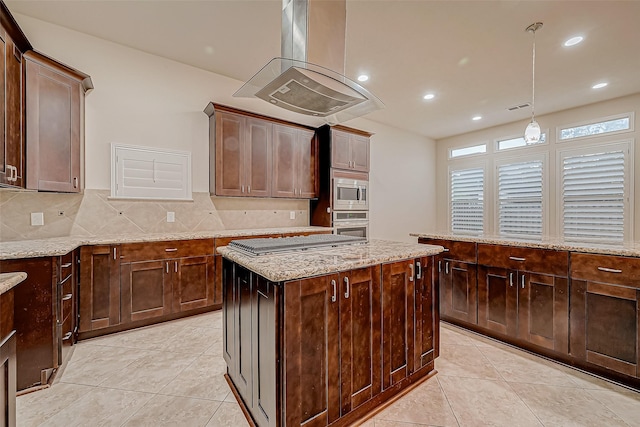 kitchen featuring dark brown cabinetry, stainless steel appliances, island exhaust hood, decorative light fixtures, and a kitchen island