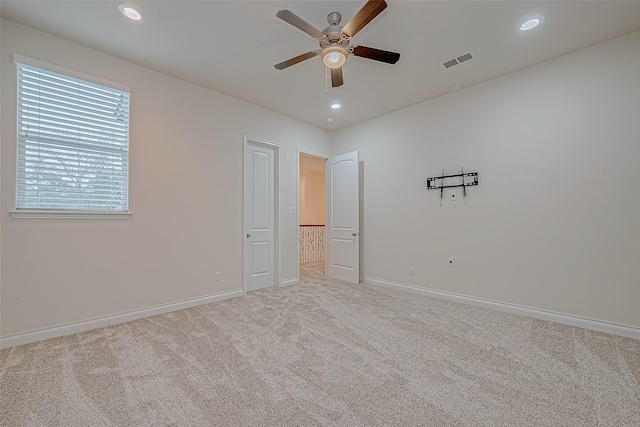 unfurnished bedroom with light carpet and ceiling fan