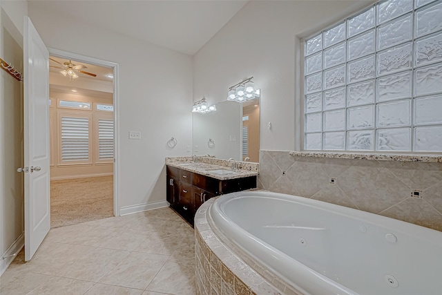 bathroom featuring tile patterned flooring, vanity, ceiling fan, and a relaxing tiled tub