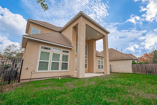 rear view of property featuring a yard and a patio area