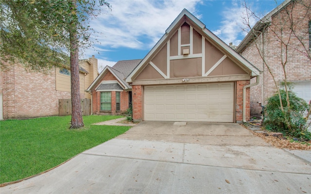 tudor-style house with a front lawn and a garage