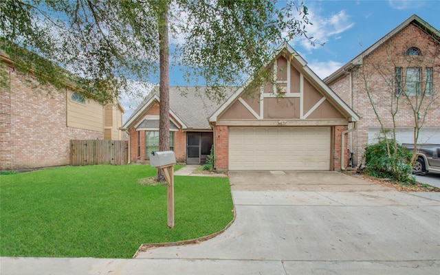 view of front of property with a front yard and a garage