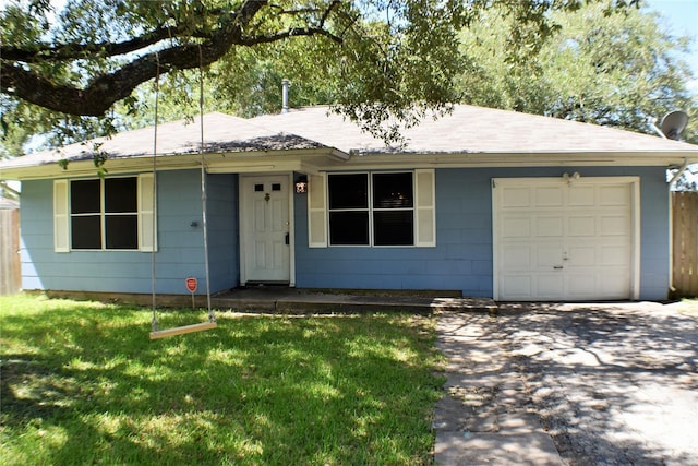 ranch-style home with a garage and a front lawn