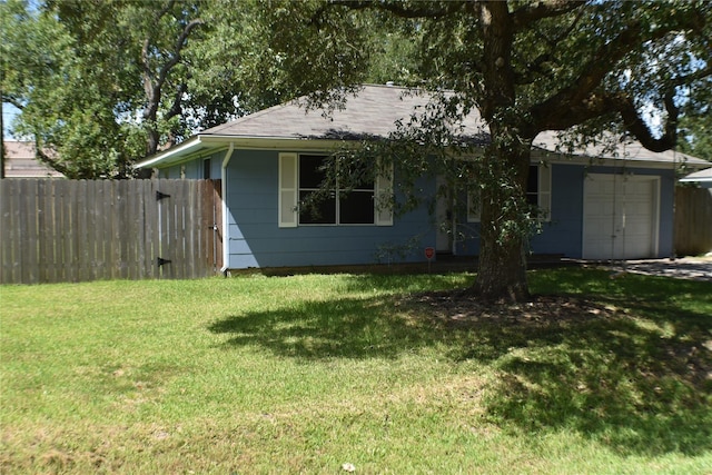 ranch-style home with a garage and a front yard