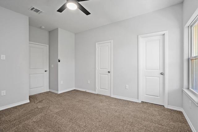 unfurnished bedroom featuring ceiling fan and carpet floors