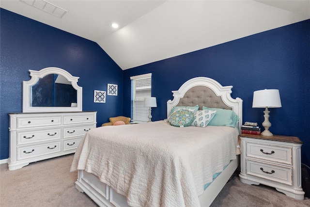 bedroom featuring light colored carpet and lofted ceiling