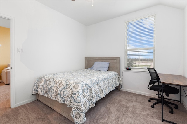 bedroom with carpet floors and lofted ceiling