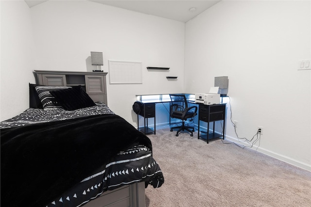 carpeted bedroom with lofted ceiling