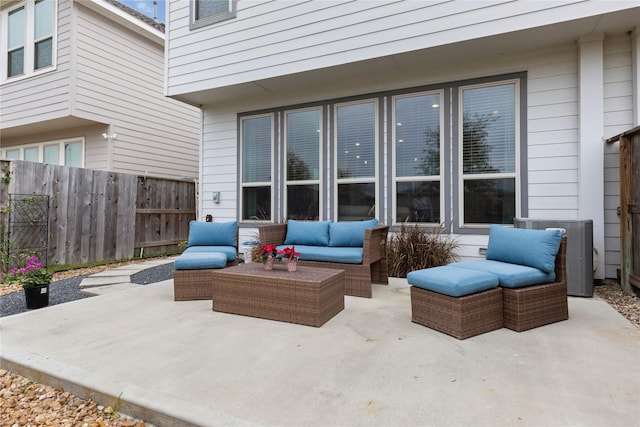 view of patio / terrace with central AC unit and an outdoor living space