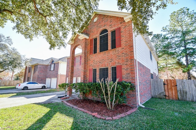 view of front of home with a front yard and a garage