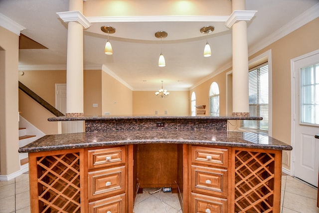 kitchen featuring pendant lighting, light tile patterned flooring, and decorative columns