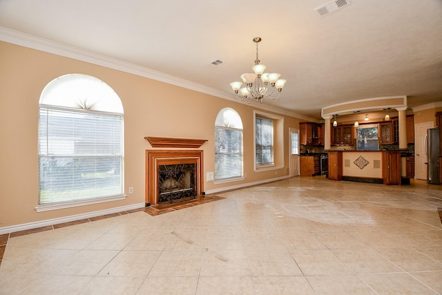 unfurnished living room with an inviting chandelier, crown molding, and light tile patterned flooring