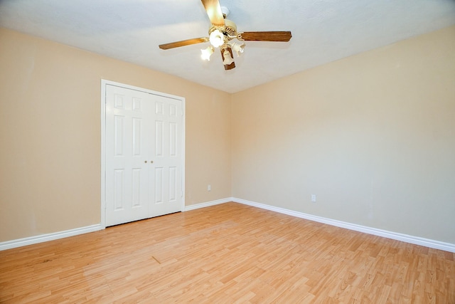 unfurnished bedroom with light wood-type flooring, a closet, and ceiling fan