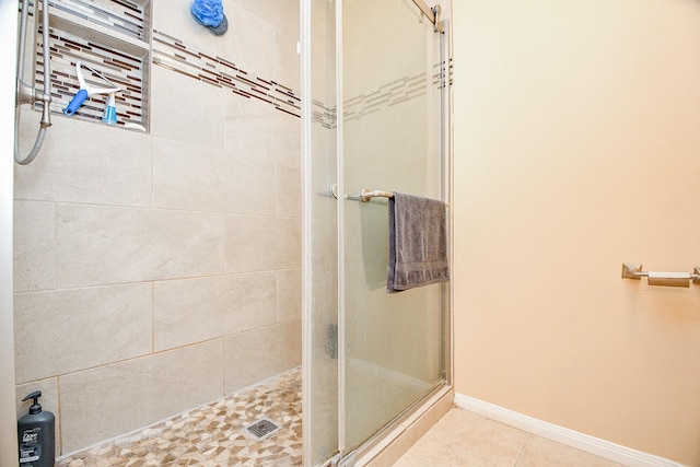 bathroom with tile patterned flooring and an enclosed shower