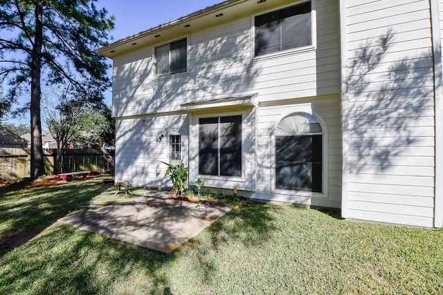 rear view of house featuring a yard and a patio area