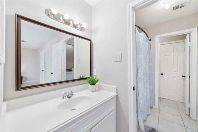 bathroom with tile patterned floors and vanity