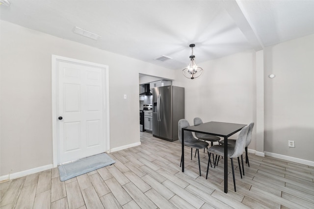 dining space featuring a notable chandelier and light hardwood / wood-style floors