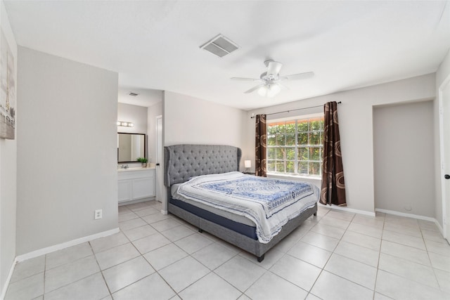 tiled bedroom featuring ensuite bathroom and ceiling fan