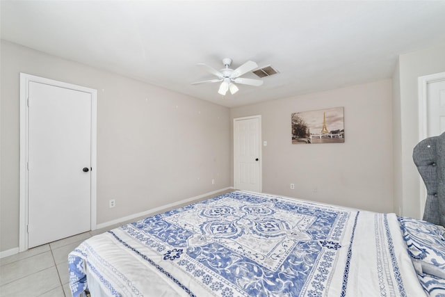 tiled bedroom featuring ceiling fan