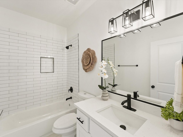 full bathroom with vanity, tiled shower / bath combo, and toilet