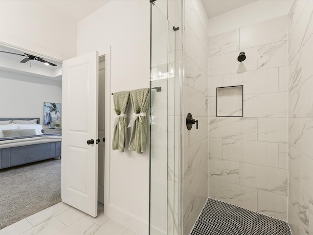 bathroom with a tile shower and ceiling fan