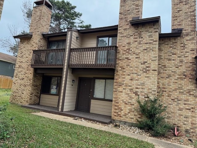 back of house featuring a balcony