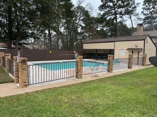 view of swimming pool with a yard and a patio area