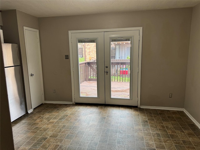 doorway featuring french doors and a textured ceiling