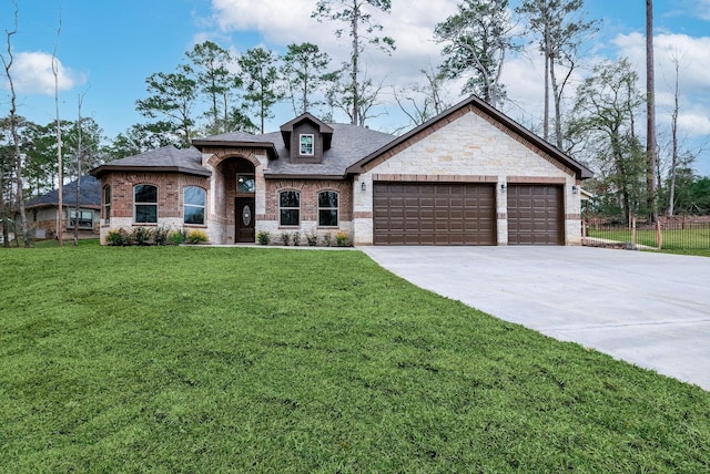 view of front of home featuring a front yard and a garage