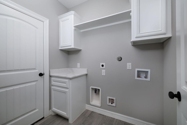 laundry room with hookup for an electric dryer, washer hookup, cabinets, dark hardwood / wood-style floors, and hookup for a gas dryer