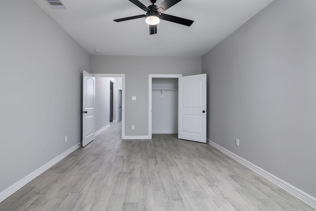 unfurnished bedroom featuring ceiling fan, a closet, and light hardwood / wood-style floors