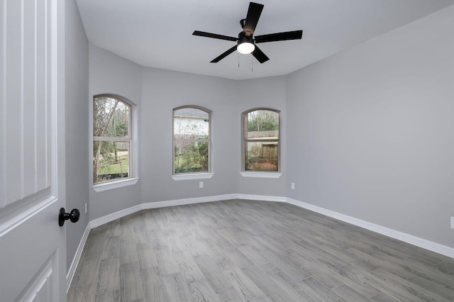 empty room with ceiling fan and light wood-type flooring