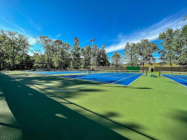 view of tennis court with basketball hoop