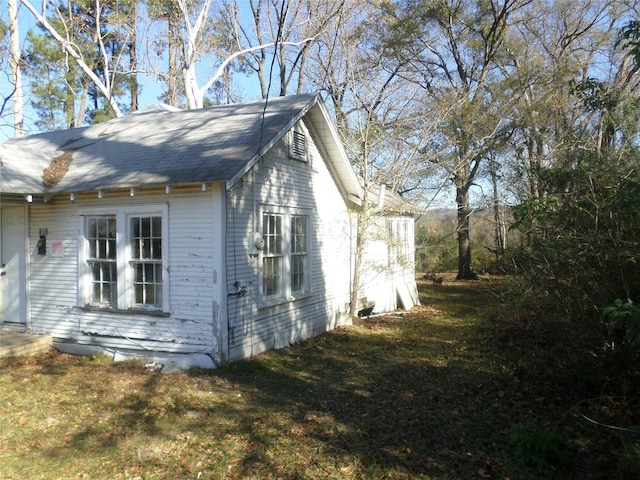 view of home's exterior with a lawn