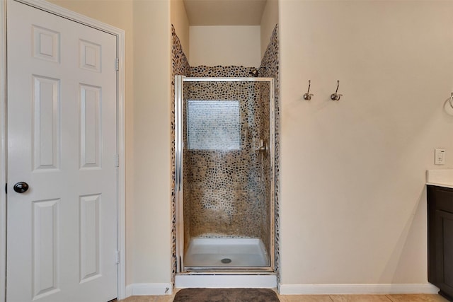 bathroom featuring vanity and a shower with door