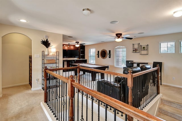 living room with plenty of natural light, ceiling fan, and light carpet