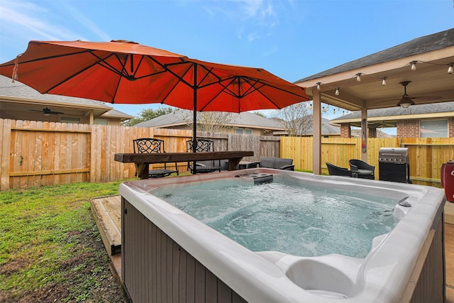 view of swimming pool featuring a grill and a hot tub