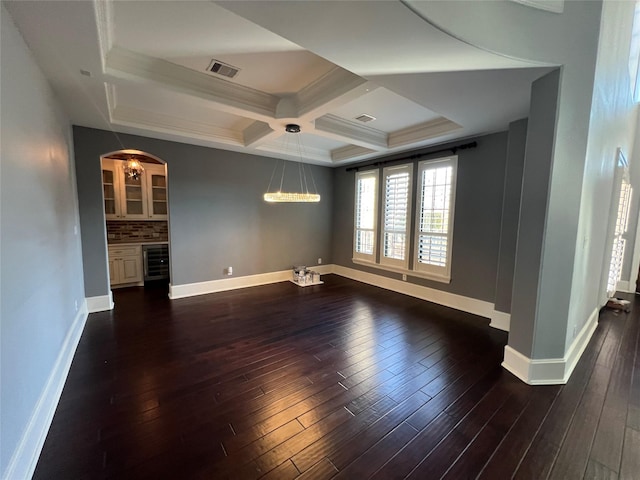 spare room with dark wood-type flooring, beverage cooler, and coffered ceiling