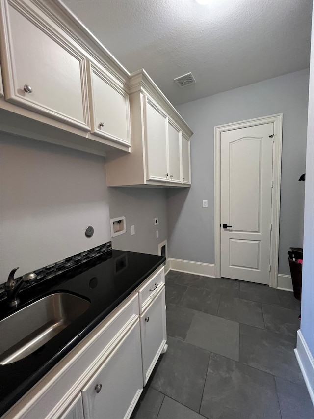 kitchen with sink and a textured ceiling