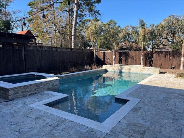 view of pool with an in ground hot tub and a patio area