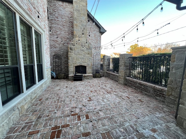 view of patio with an outdoor stone fireplace