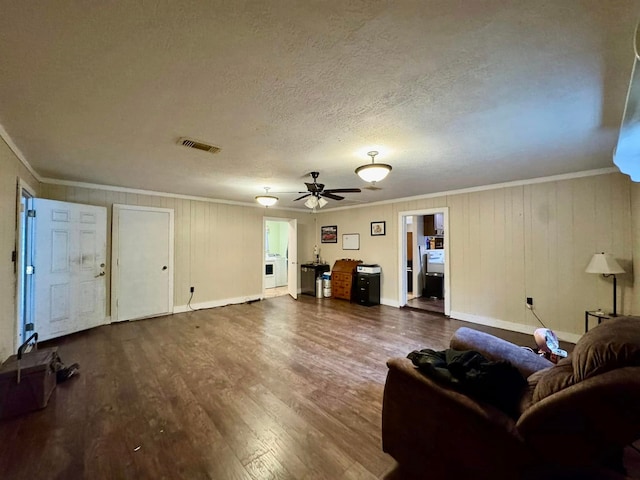 living room with hardwood / wood-style flooring, ceiling fan, crown molding, and a textured ceiling