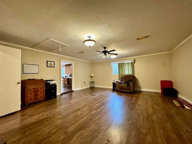 unfurnished room with ceiling fan, dark hardwood / wood-style flooring, a textured ceiling, and ornamental molding