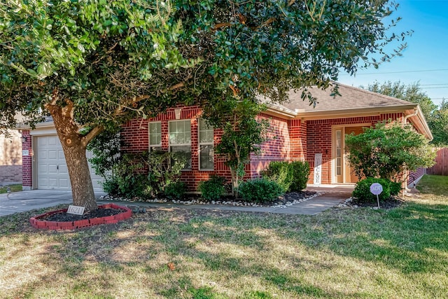 obstructed view of property featuring a garage and a front lawn