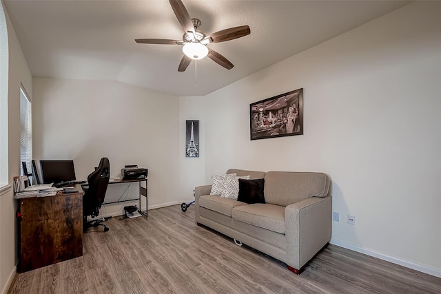 office area featuring ceiling fan, vaulted ceiling, and hardwood / wood-style flooring