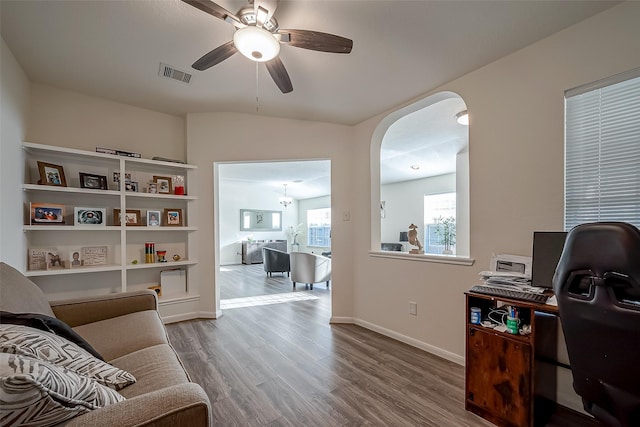 office area with hardwood / wood-style floors, ceiling fan with notable chandelier, and vaulted ceiling