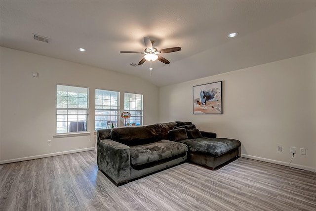 living room featuring ceiling fan, vaulted ceiling, and light hardwood / wood-style flooring