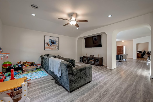 living room featuring ceiling fan, vaulted ceiling, and hardwood / wood-style flooring