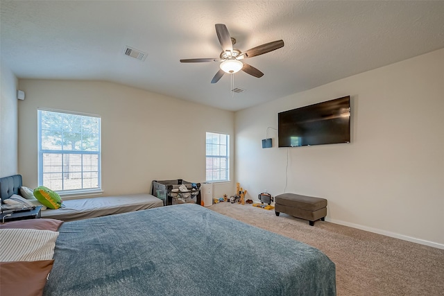 bedroom with ceiling fan, carpet floors, and lofted ceiling