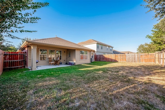 rear view of property featuring a yard and a patio